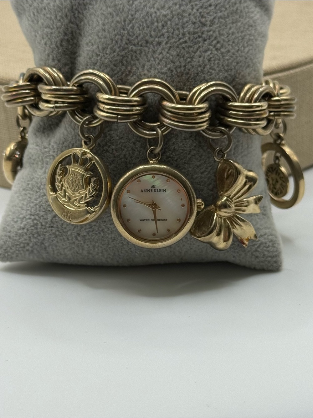 Anne Klein Gold Charm Bracelet Watch with Mother-of-Pearl Dial & Bow Charm